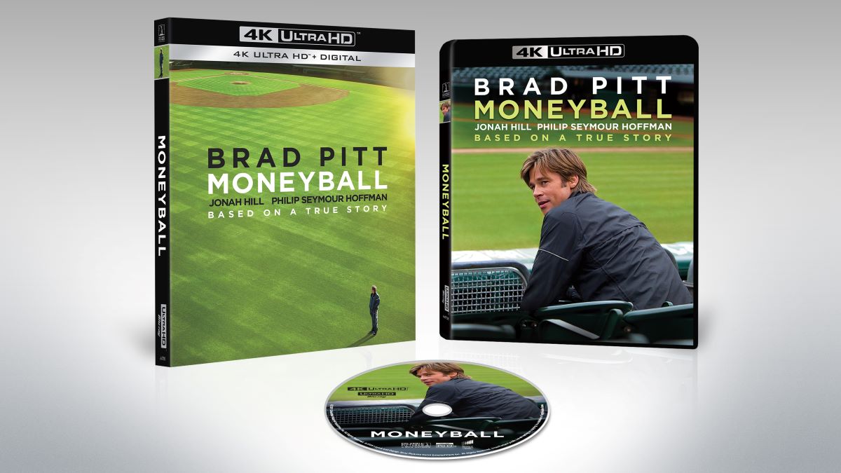 Packaging of the movie 'Moneyball' featuring Brad Pitt, including a disc and cover art with a baseball field background.