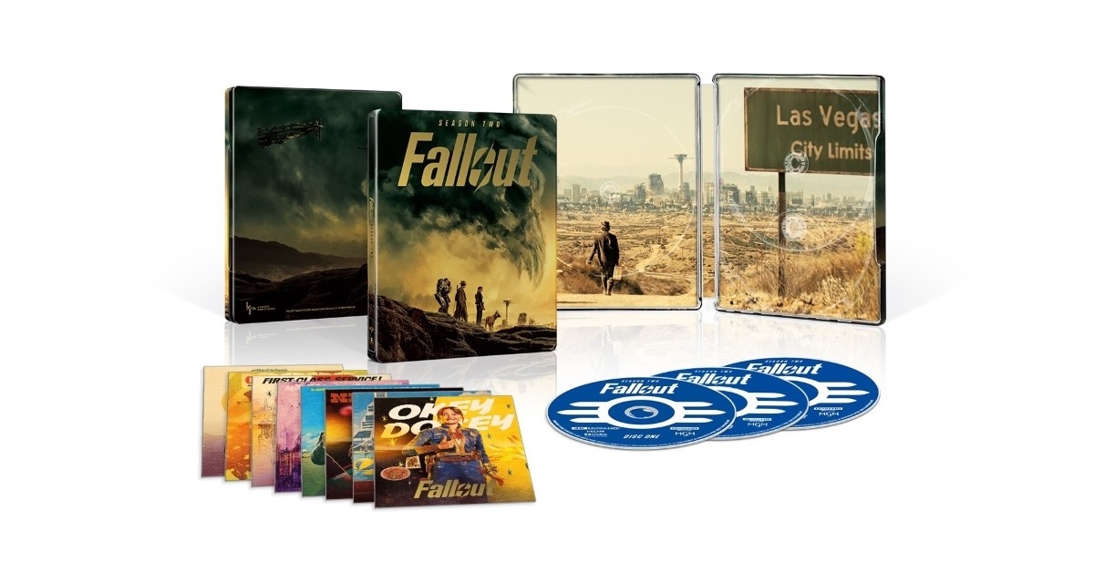 A collection of 'Fallout' media, including a steelbook case, art cards, and discs. The steelbook features a dramatic landscape with characters, and the interior image shows a Las Vegas city limit sign.